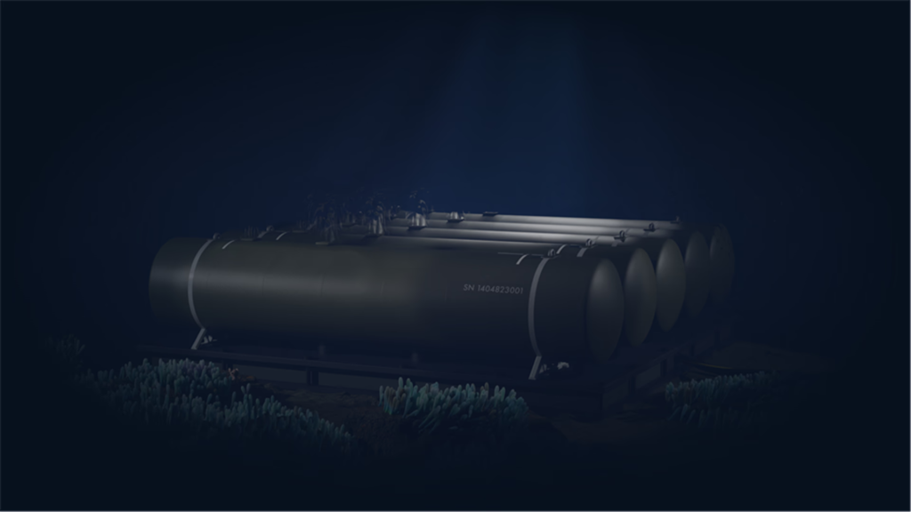 Row of large black cylindrical storage tanks on a metal platform in a dark underwater setting, illuminated by a dim blue glow.